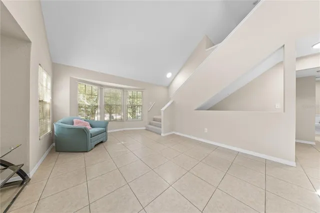 a large kitchen with granite countertop a sink stainless steel appliances and cabinets