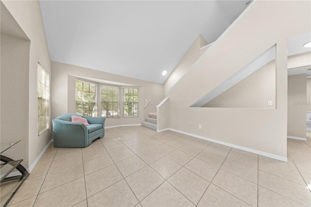 6340 Raleigh Street, Unit 1011 Orlando, FL 32835 - Photo 12 of 68 a living room with furniture and a large window