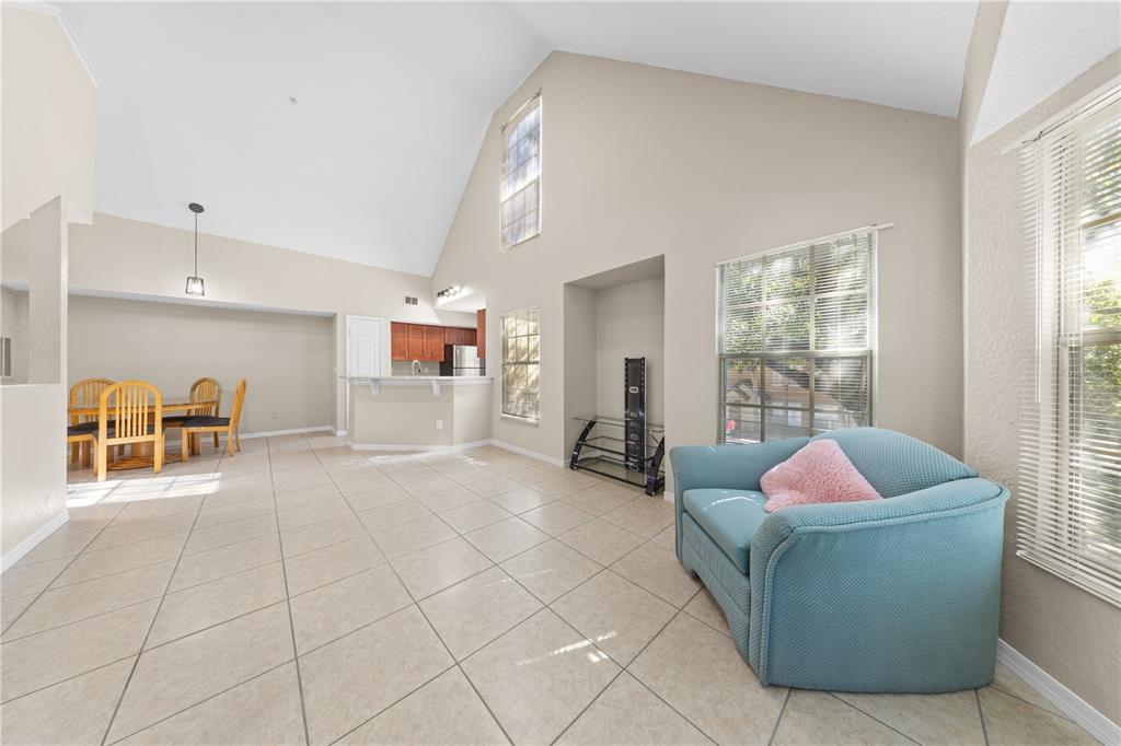 6340 Raleigh Street, Unit 1011 Orlando, FL 32835 - Photo 14 of 68 a living room with furniture and a window