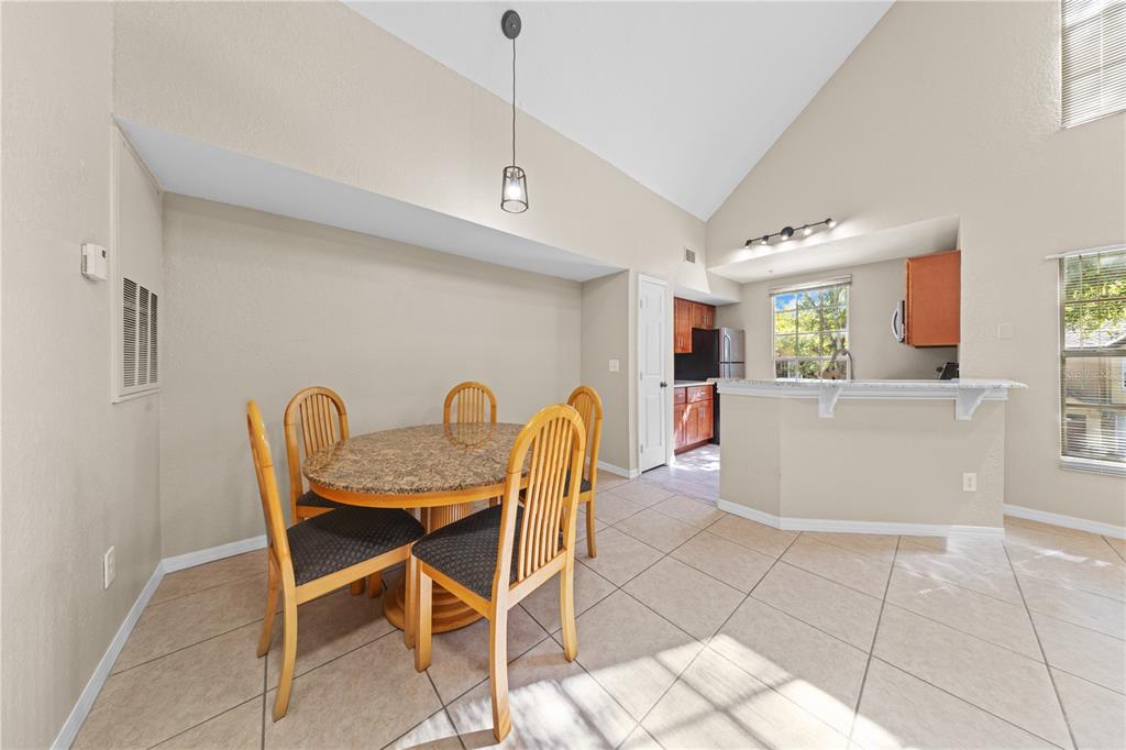 6340 Raleigh Street, Unit 1011 Orlando, FL 32835 - Photo 17 of 68 a dining room with furniture and window