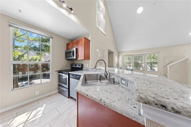 a view of a livingroom with wooden floor and a bathroom