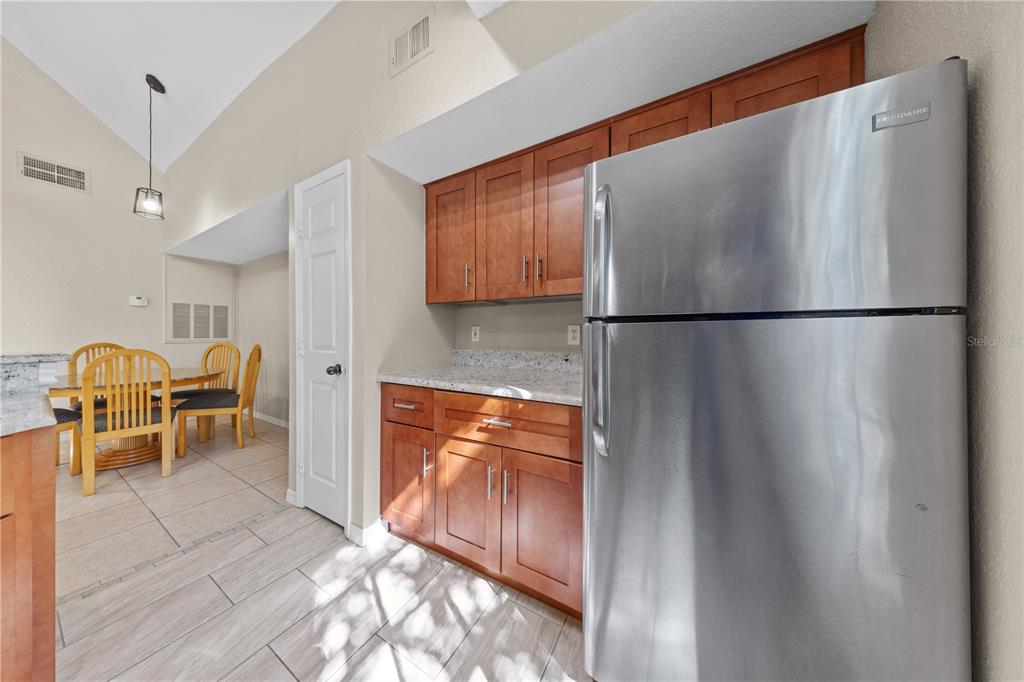 6340 Raleigh Street, Unit 1011 Orlando, FL 32835 - Photo 23 of 68 a white refrigerator freezer sitting in a kitchen