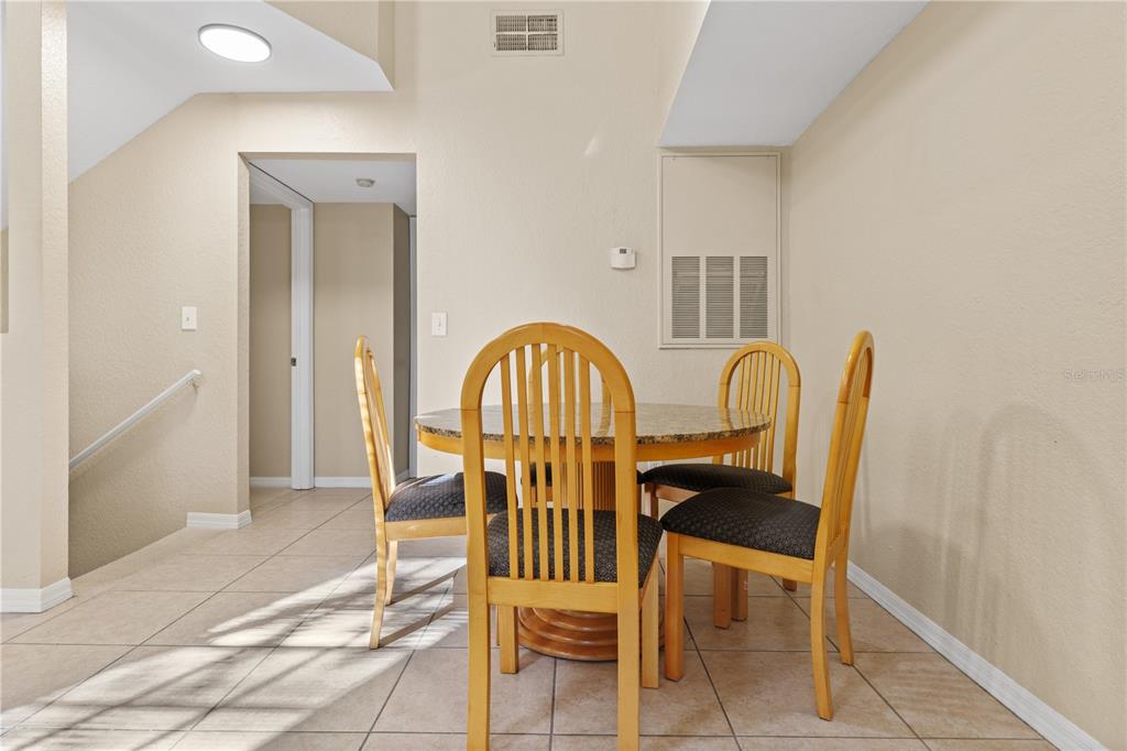 6340 Raleigh Street, Unit 1011 Orlando, FL 32835 - Photo 25 of 68 a view of a dining room with furniture and wooden floor