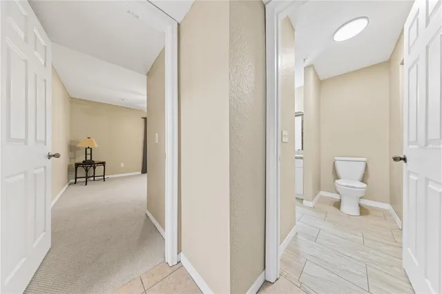 a bathroom with a granite countertop sink a mirror and a bathtub