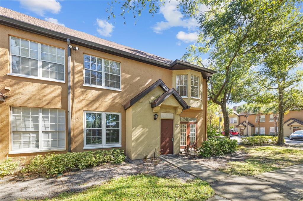 6340 Raleigh Street, Unit 1011 Orlando, FL 32835 - Photo 3 of 68 a front view of a house with a yard
