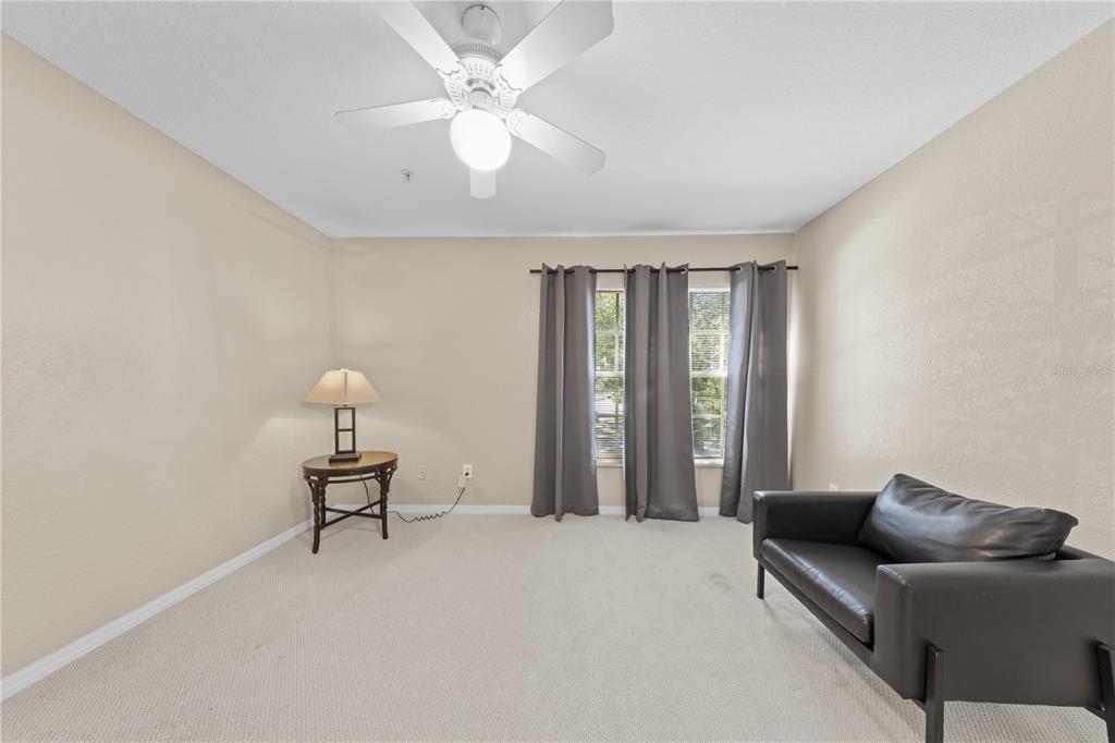 6340 Raleigh Street, Unit 1011 Orlando, FL 32835 - Photo 40 of 68 a living room with furniture and a window