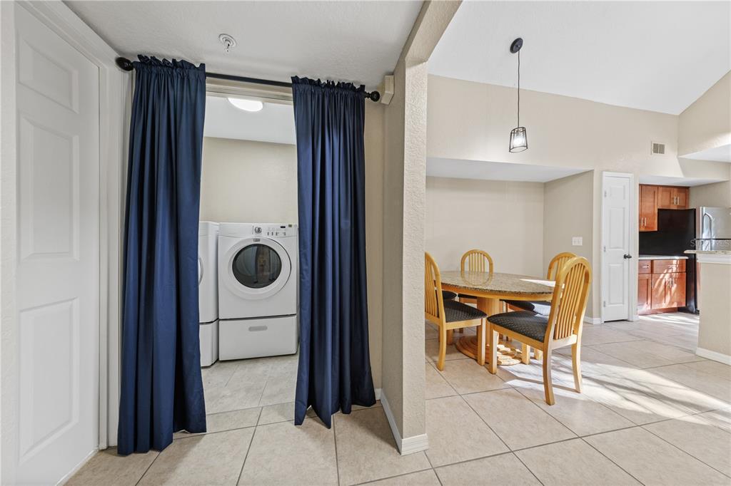 6340 Raleigh Street, Unit 1011 Orlando, FL 32835 - Photo 46 of 68 a dining room with furniture and a chandelier