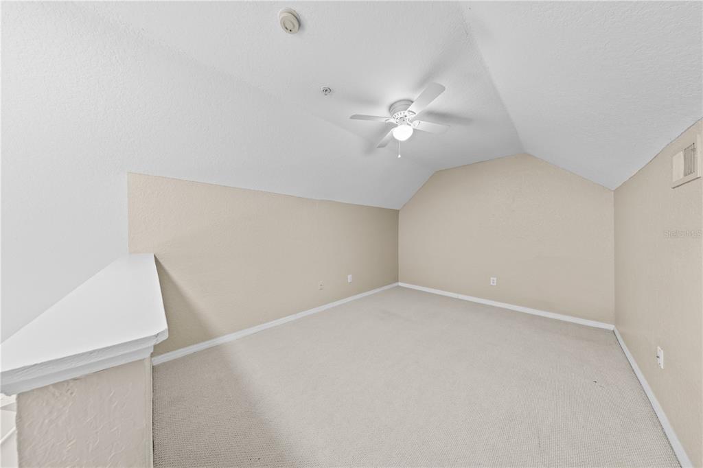 6340 Raleigh Street, Unit 1011 Orlando, FL 32835 - Photo 50 of 68 an empty room with a ceiling fan and a window