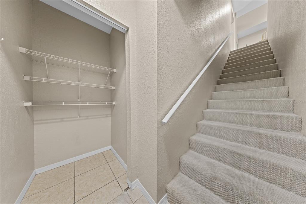6340 Raleigh Street, Unit 1011 Orlando, FL 32835 - Photo 5 of 68 a view of staircase with white walls