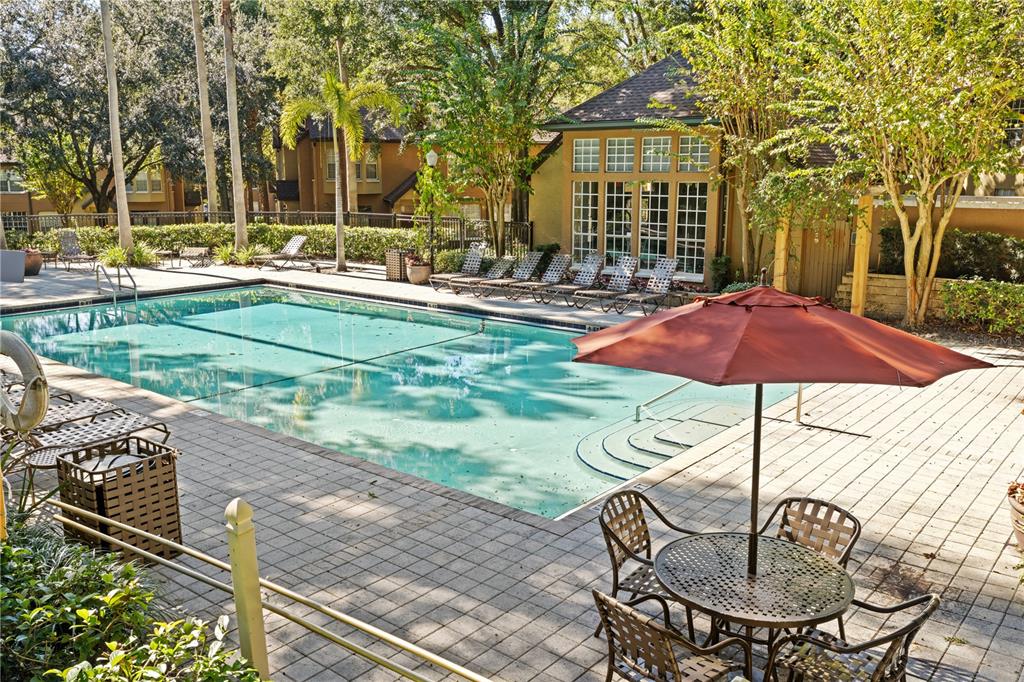 6340 Raleigh Street, Unit 1011 Orlando, FL 32835 - Photo 59 of 68 a front view of a house with garden and sitting area