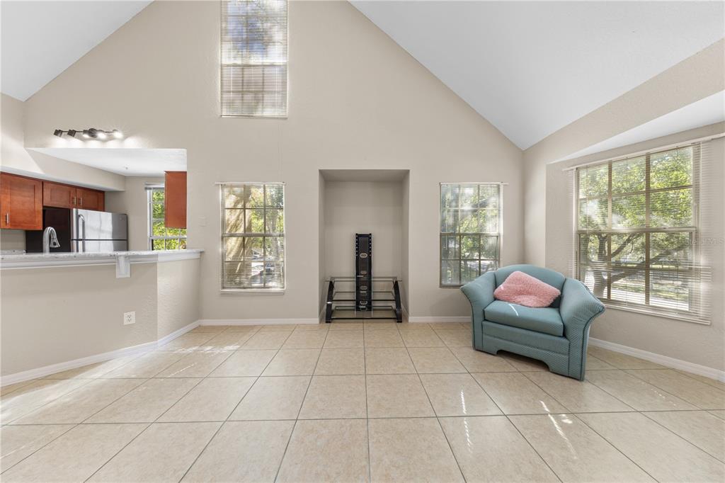 6340 Raleigh Street, Unit 1011 Orlando, FL 32835 - Photo 10 of 68 a living room with furniture and large windows