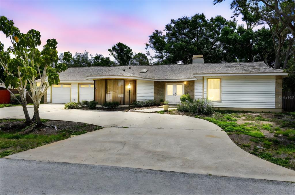 a front view of a house with a yard and a garage