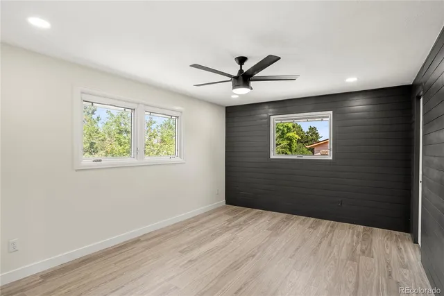 a view of empty room with wooden floor