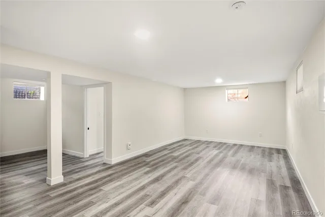 a view of wooden floor and windows in a room