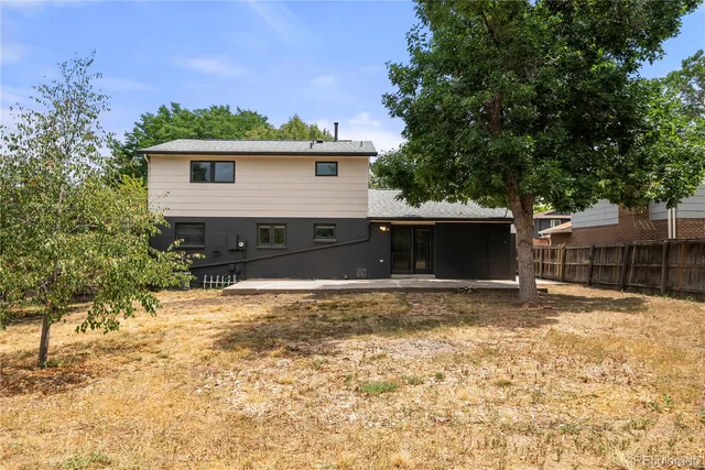 a view of a house with a yard covered with snow in the background