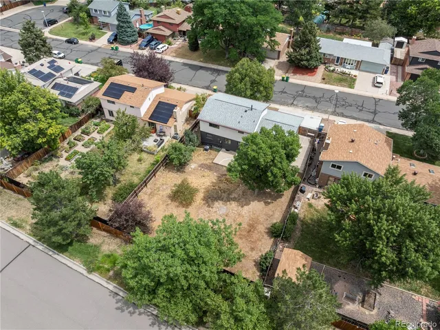 an aerial view of residential house with outdoor space and trees all around