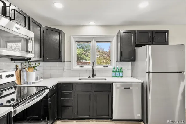 a kitchen with a sink appliances and cabinets
