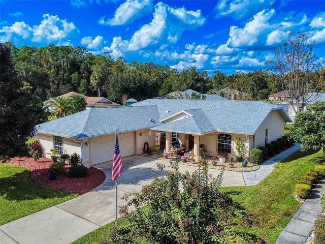 a view of a house with pool and chairs