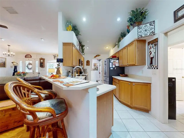 a kitchen with stainless steel appliances granite countertop a refrigerator a stove and a sink