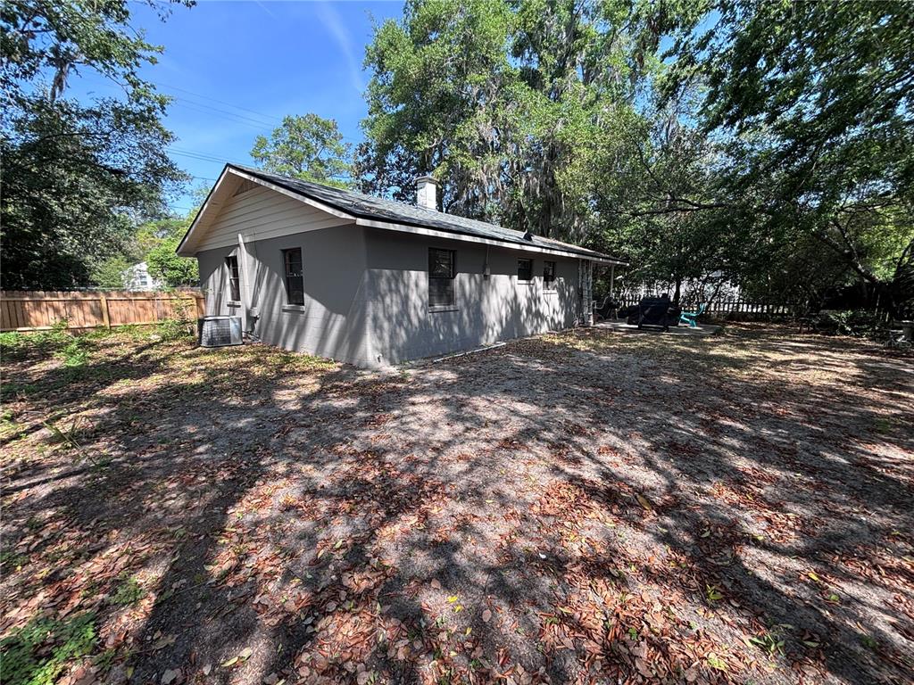 3137 Northwest 6th Street Gainesville, FL 32609 - Photo 11 of 11 a backyard of a house with large trees