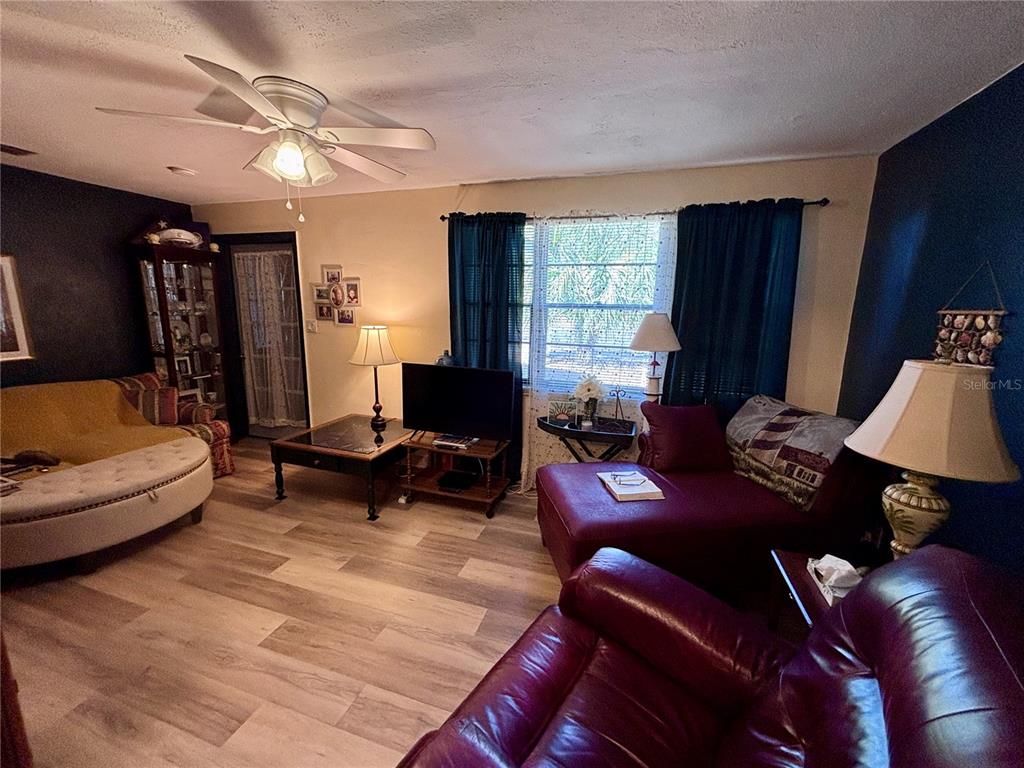 3137 Northwest 6th Street Gainesville, FL 32609 - Photo 2 of 11 a living room with furniture and a flat screen tv