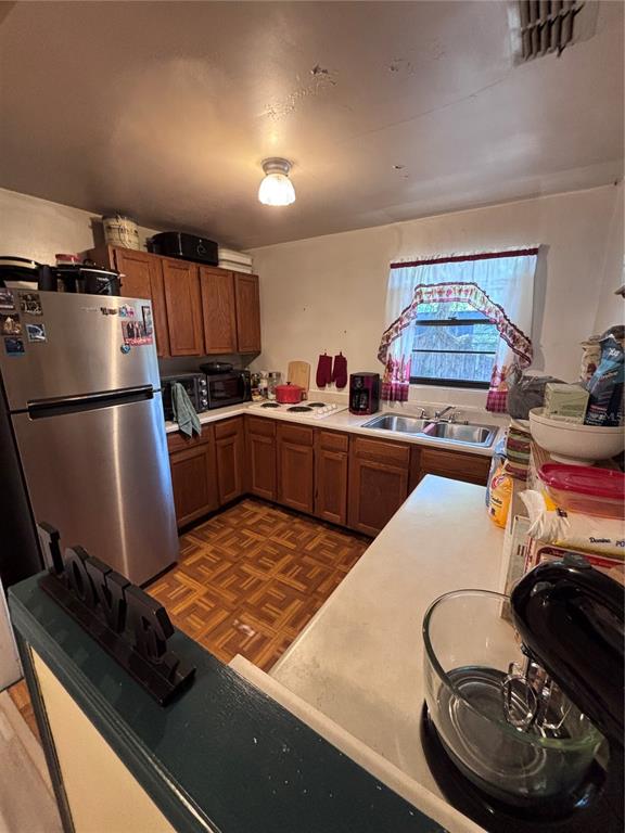 3137 Northwest 6th Street Gainesville, FL 32609 - Photo 3 of 11 a kitchen with stainless steel appliances granite countertop a sink stove and refrigerator