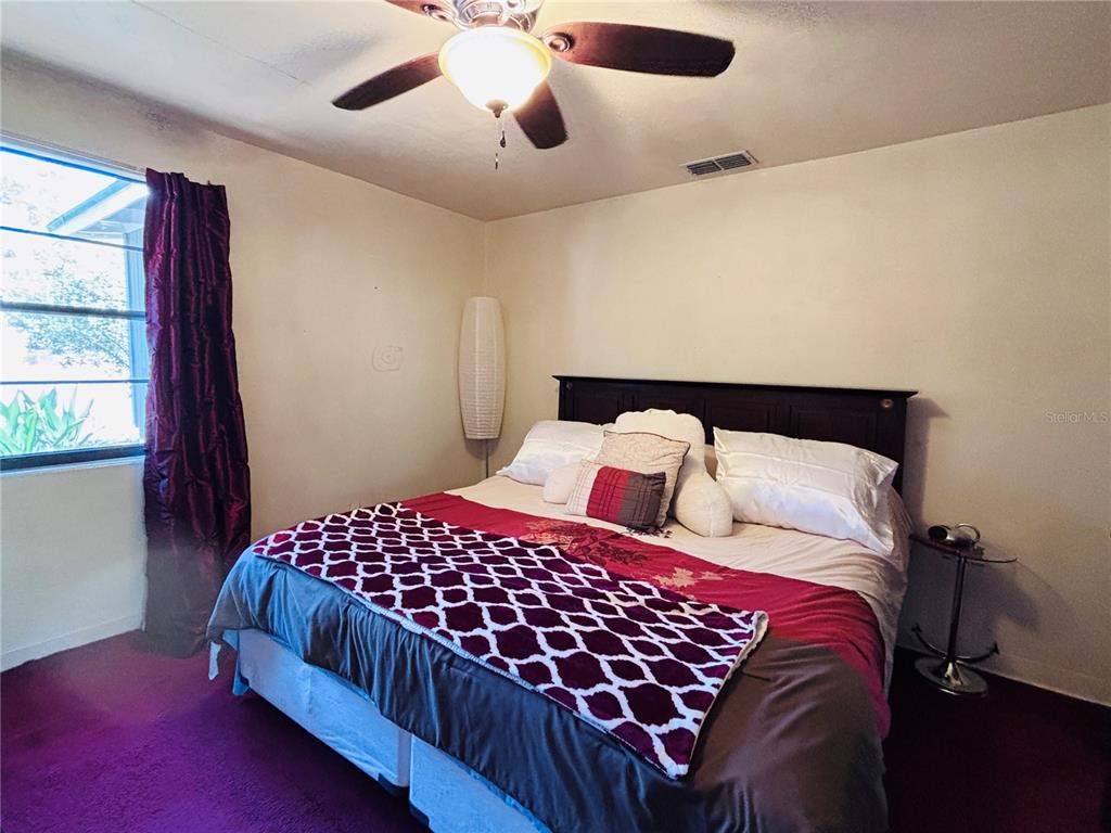 3137 Northwest 6th Street Gainesville, FL 32609 - Photo 5 of 11 a bedroom with a large bed and a window