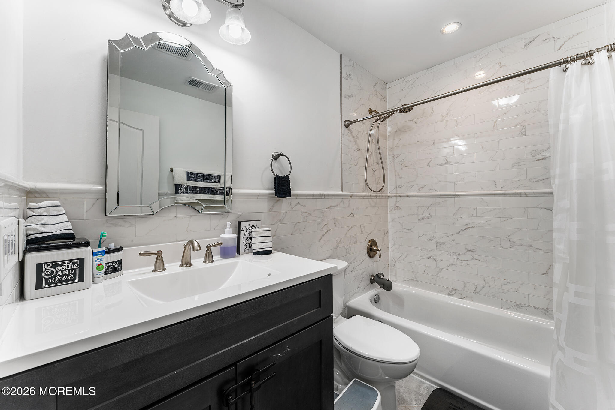 8 Cindy Court Howell, NJ 07731 - Photo 49 of 63 a bathroom with a bathtub shower sink vanity mirror and toilet
