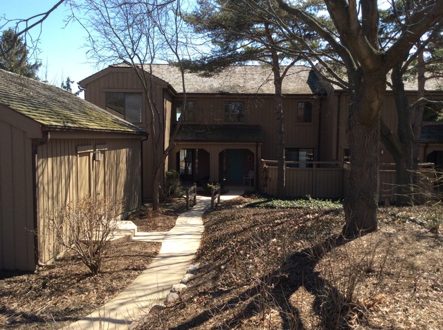a view of a house with a yard covered in snow