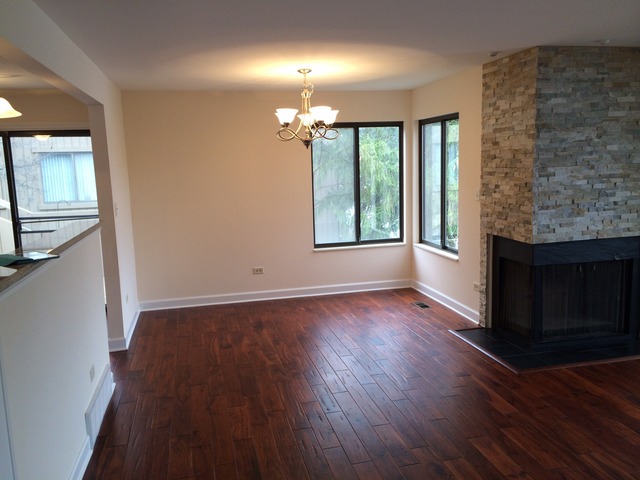 305 Shoreline Road, Unit 305 Lake Barrington, IL 60010 - Photo 7 of 23 an empty room with wooden floor and windows