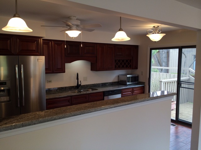305 Shoreline Road, Unit 305 Lake Barrington, IL 60010 - Photo 8 of 23 a kitchen with stainless steel appliances granite countertop a refrigerator a sink and a stove