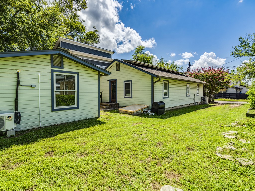 2314 Santa Rosa Street Austin, TX 78702 - Photo 19 of 27 Back of house with a lawn