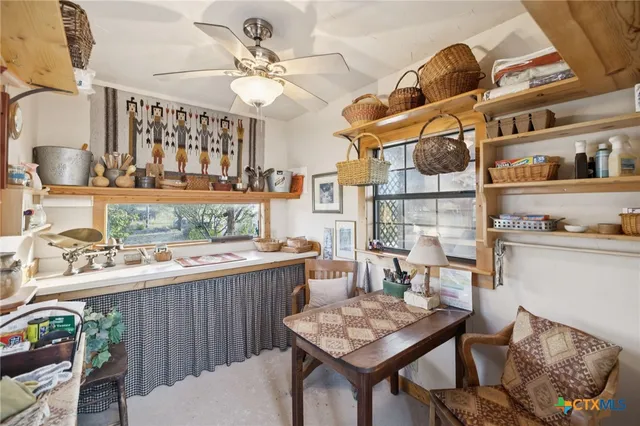 a living room with furniture a rug and a large window