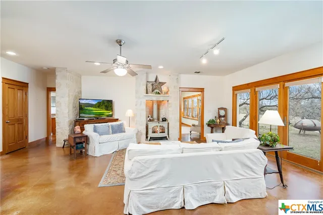 a living room with furniture dining area and a large window