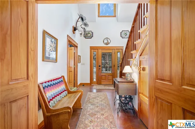 a kitchen with stainless steel appliances a sink a stove and wooden floor