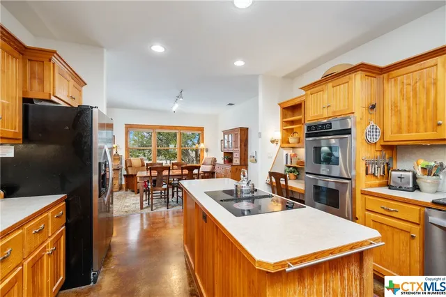 a kitchen with sink refrigerator and window