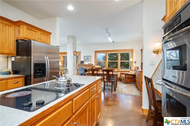 a kitchen with stainless steel appliances granite countertop a stove and a refrigerator