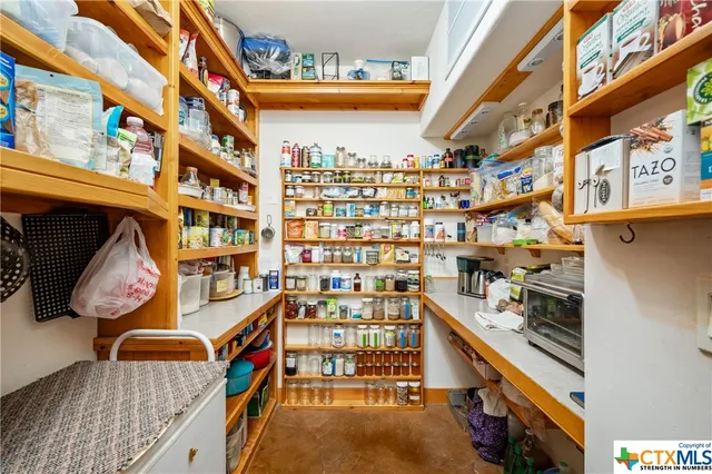a bedroom with furniture and a large window