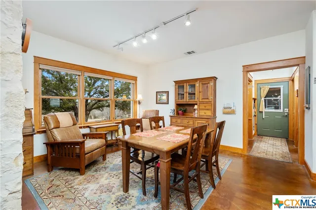 a living room with furniture a window and a chandelier