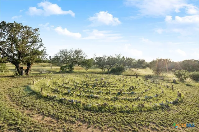 an aerial view of a house with a yard and garden