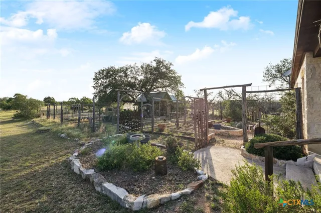 a front view of a house with garden and sitting area