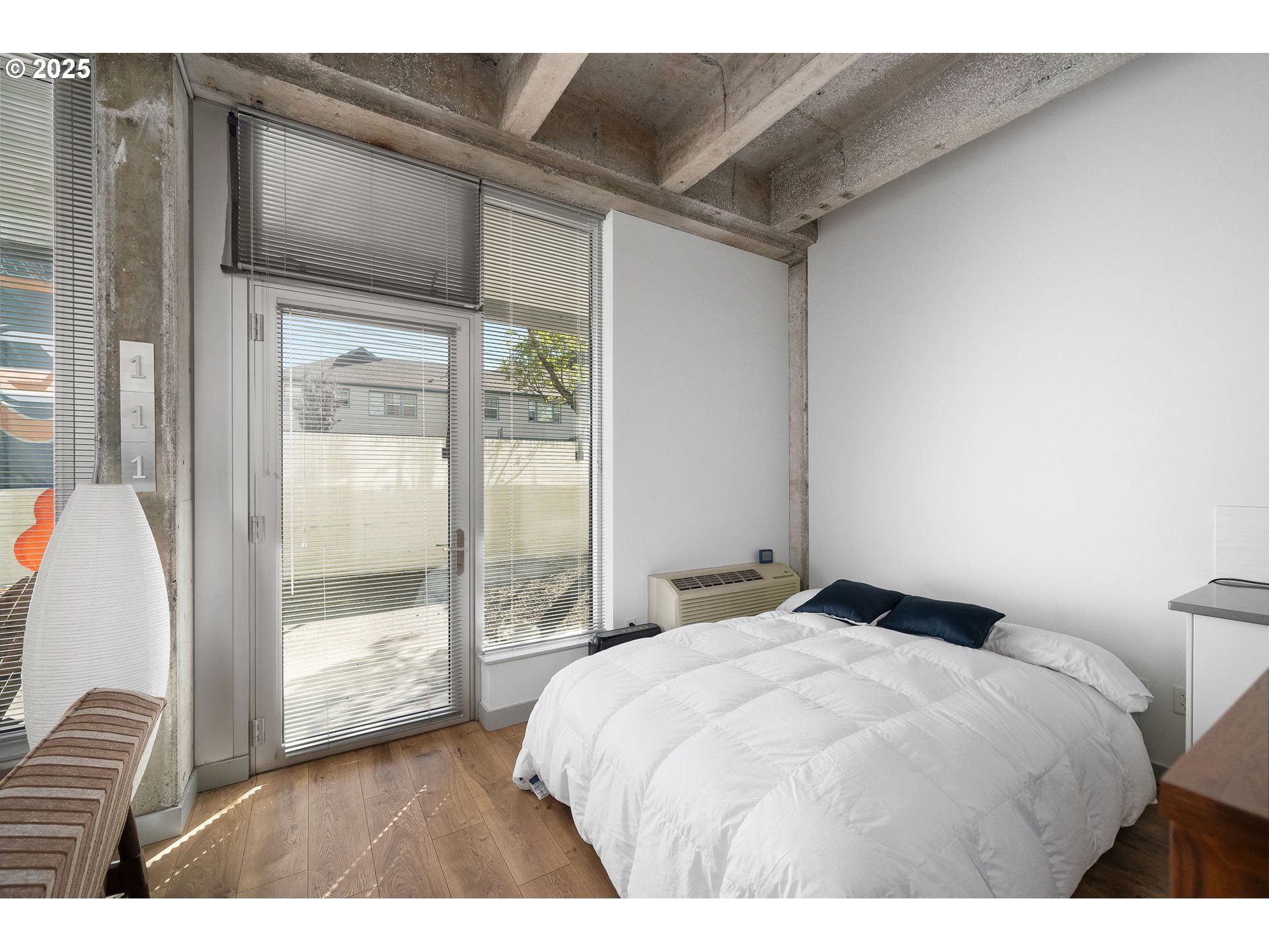 900 Northeast 81st Avenue, Unit 111 Portland, OR 97213 - Photo 12 of 25 a bedroom with a bed and a large window