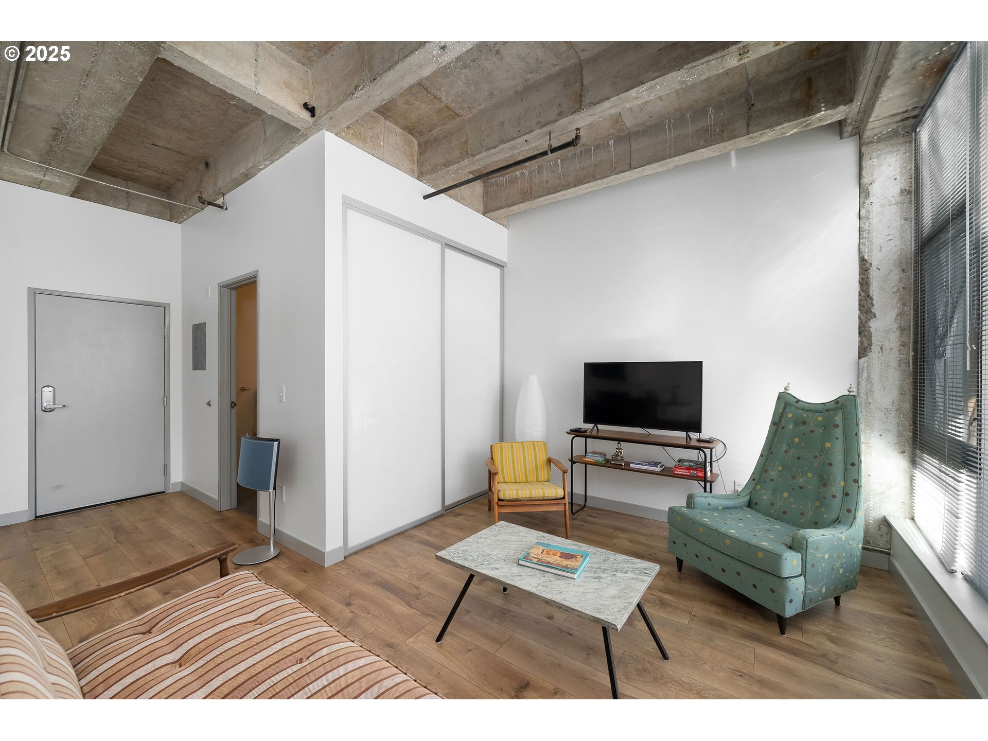 900 Northeast 81st Avenue, Unit 111 Portland, OR 97213 - Photo 14 of 25 a living room with furniture and a flat screen tv