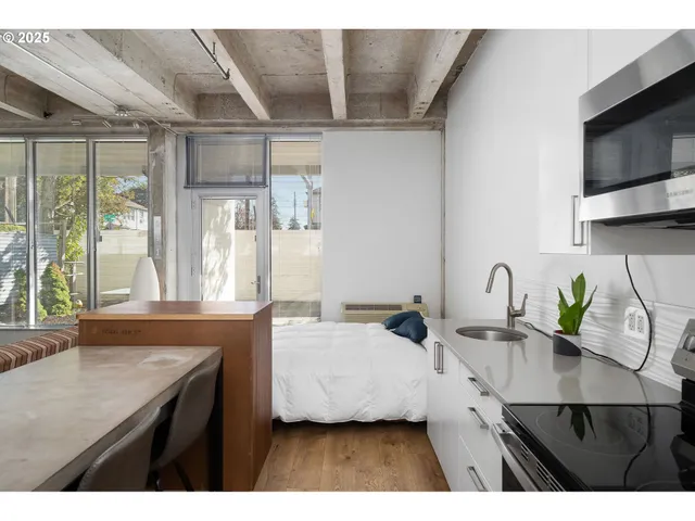 a kitchen with a sink a counter top space cabinets and stainless steel appliances