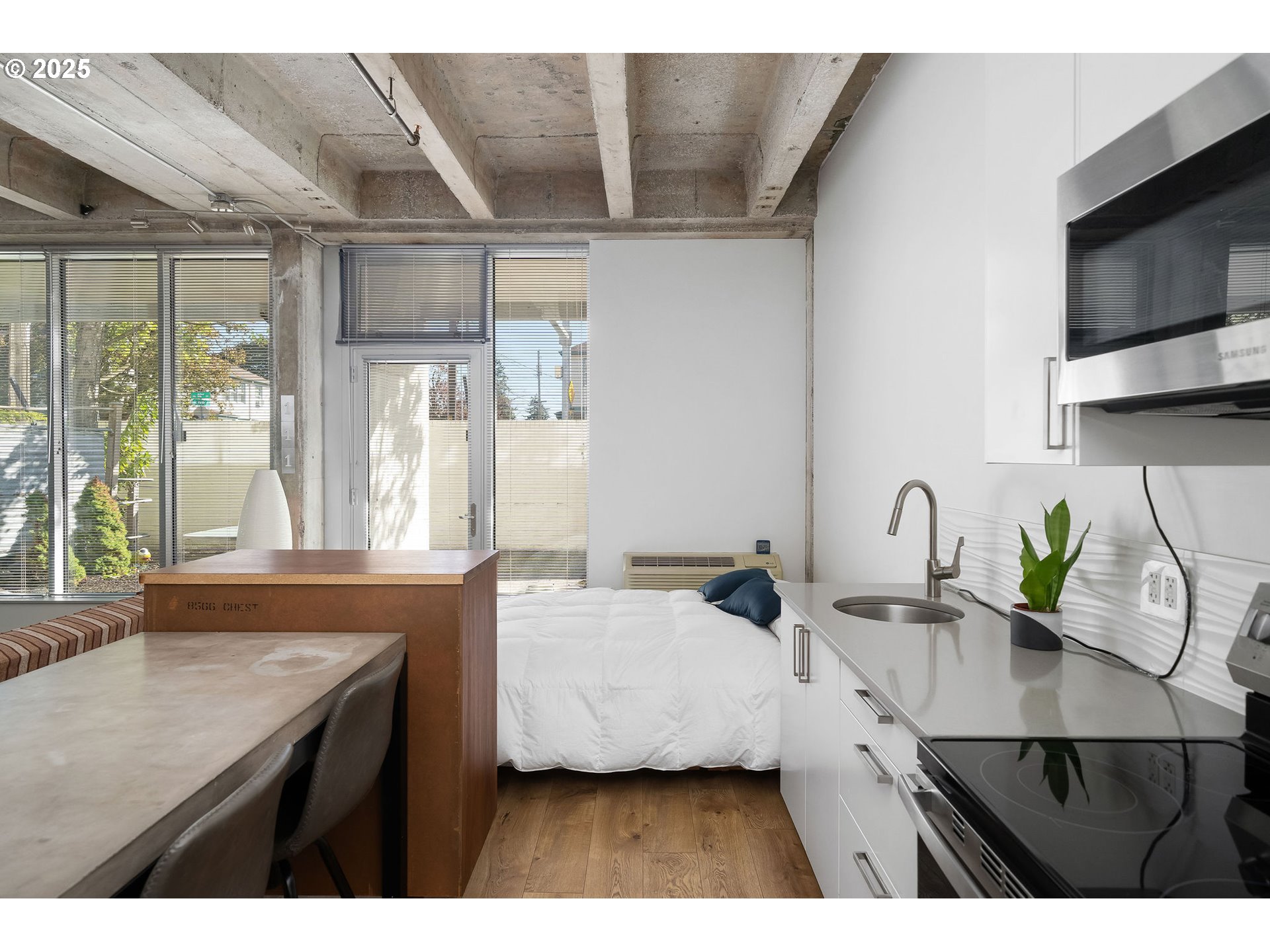 900 Northeast 81st Avenue, Unit 111 Portland, OR 97213 - Photo 6 of 25 a kitchen with a sink a counter top space cabinets and stainless steel appliances