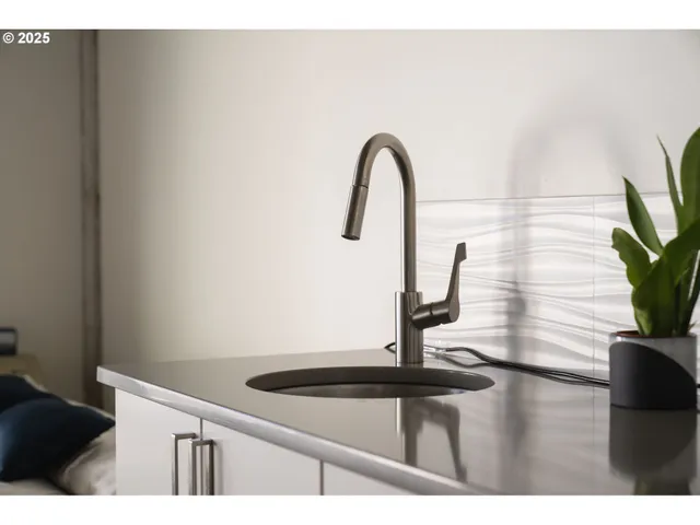 a kitchen with stainless steel appliances a refrigerator and a stove