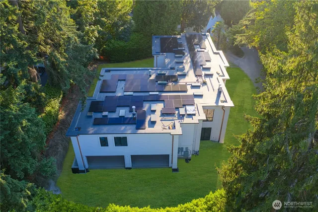 an aerial view of a house with swimming pool and garden