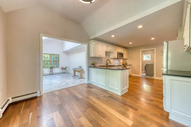 a kitchen with a refrigerator and a stove top oven