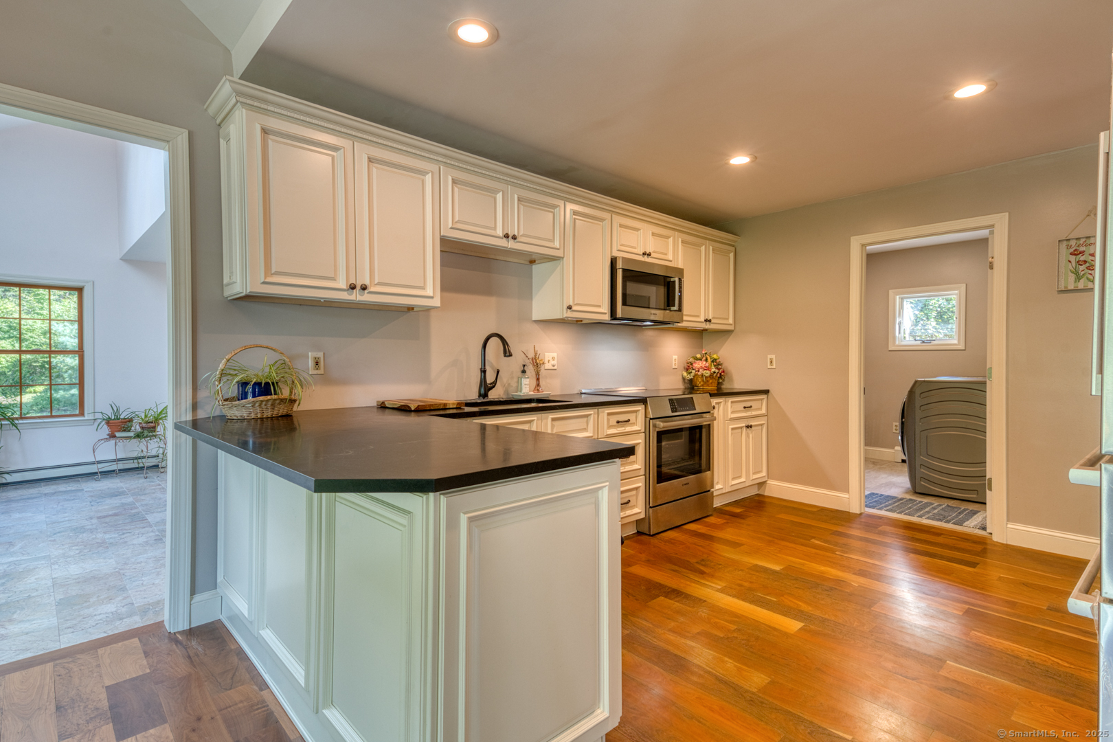 287 South Bear Hill Road Chaplin, CT 06235 - Photo 12 of 40 a kitchen with stainless steel appliances granite countertop a sink stove refrigerator and cabinets