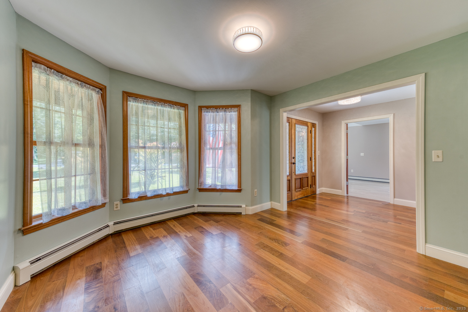 287 South Bear Hill Road Chaplin, CT 06235 - Photo 17 of 40 an empty room with wooden floor and windows